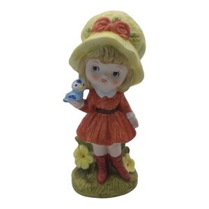 Blonde Hair Girl Holding Blue Bird Figurine